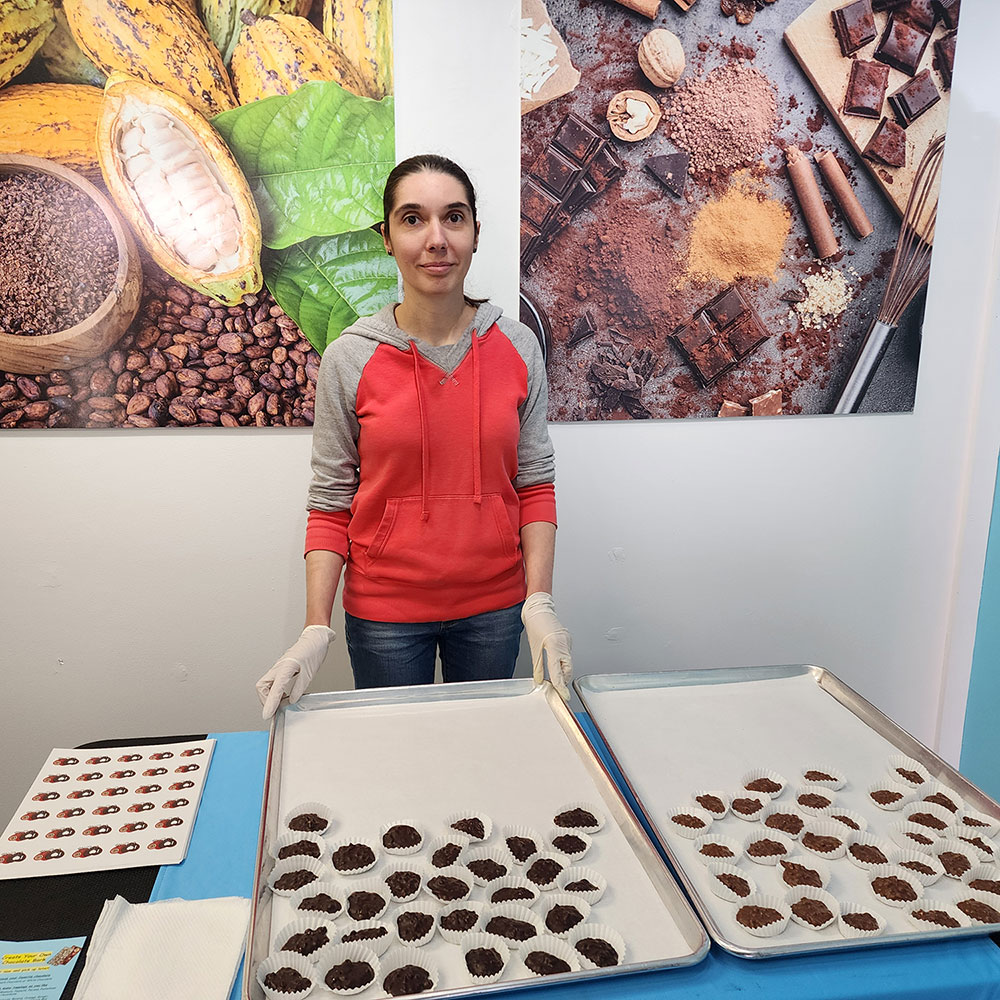 Carmen Kulik of Chocolate Wave displays her superbly delicious, homemade dark and milk chocolate peanut clusters.