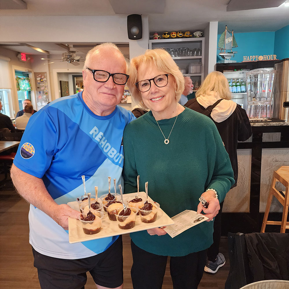 Folks at Sunny Bay pass out Chef Laurie’s beignets with chocolate dip. There is a tasty surprise center that make the beignet extra special.